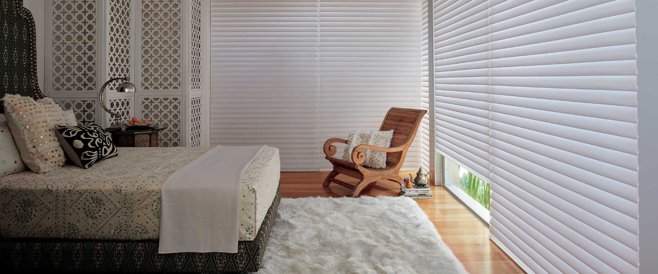 Traditional bedroom with area rug and chair.